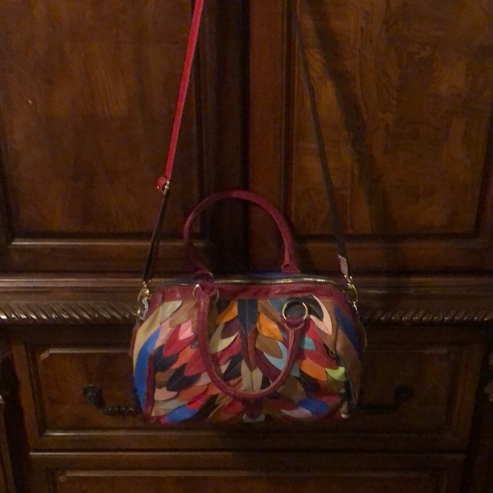 Really cute multi color handbag with long cross body strap